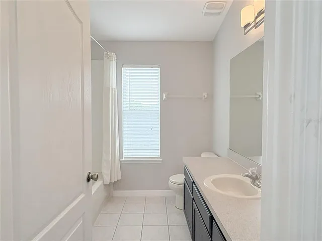 a view of empty room with wooden floor and fireplace