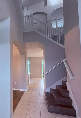 a view of entryway and hall with a staircase