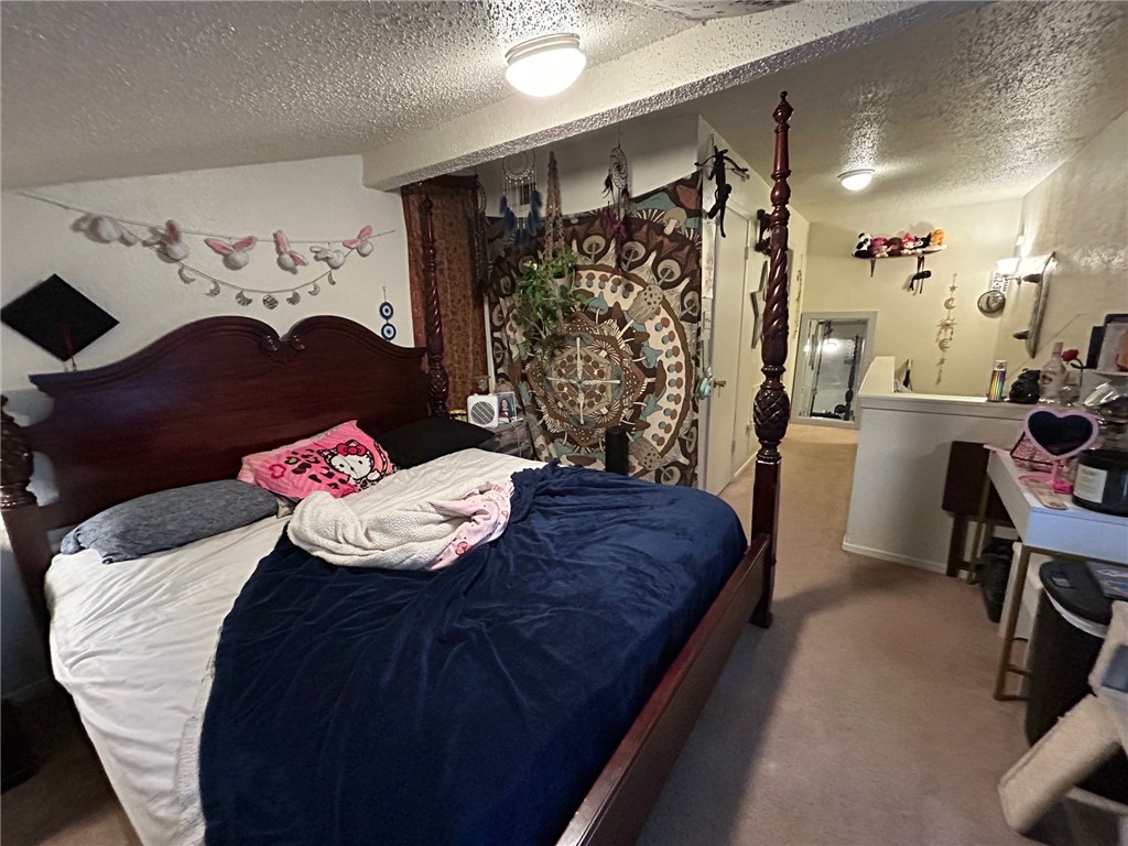 4405 Carter Creek Parkway, Unit 9 Bryan, TX 77802 - Photo 7 of 11 a bedroom with a bed and a dresser