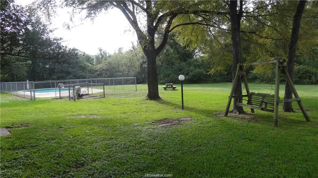 4405 Carter Creek Parkway, Unit 9 Bryan, TX 77802 - Photo 9 of 11 a view of a park with swings