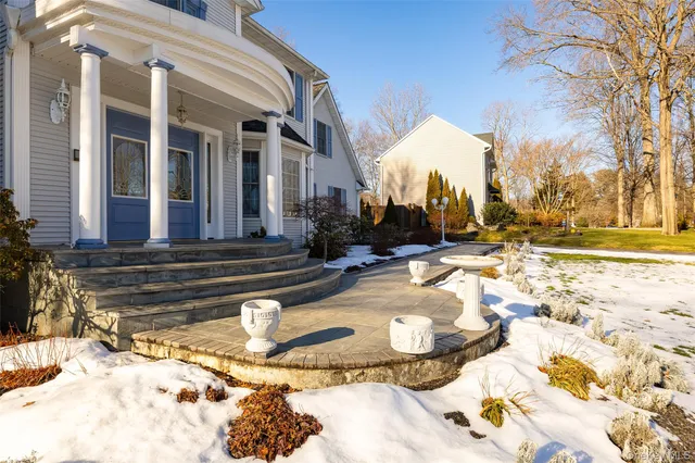 a view of a house with snow on the road