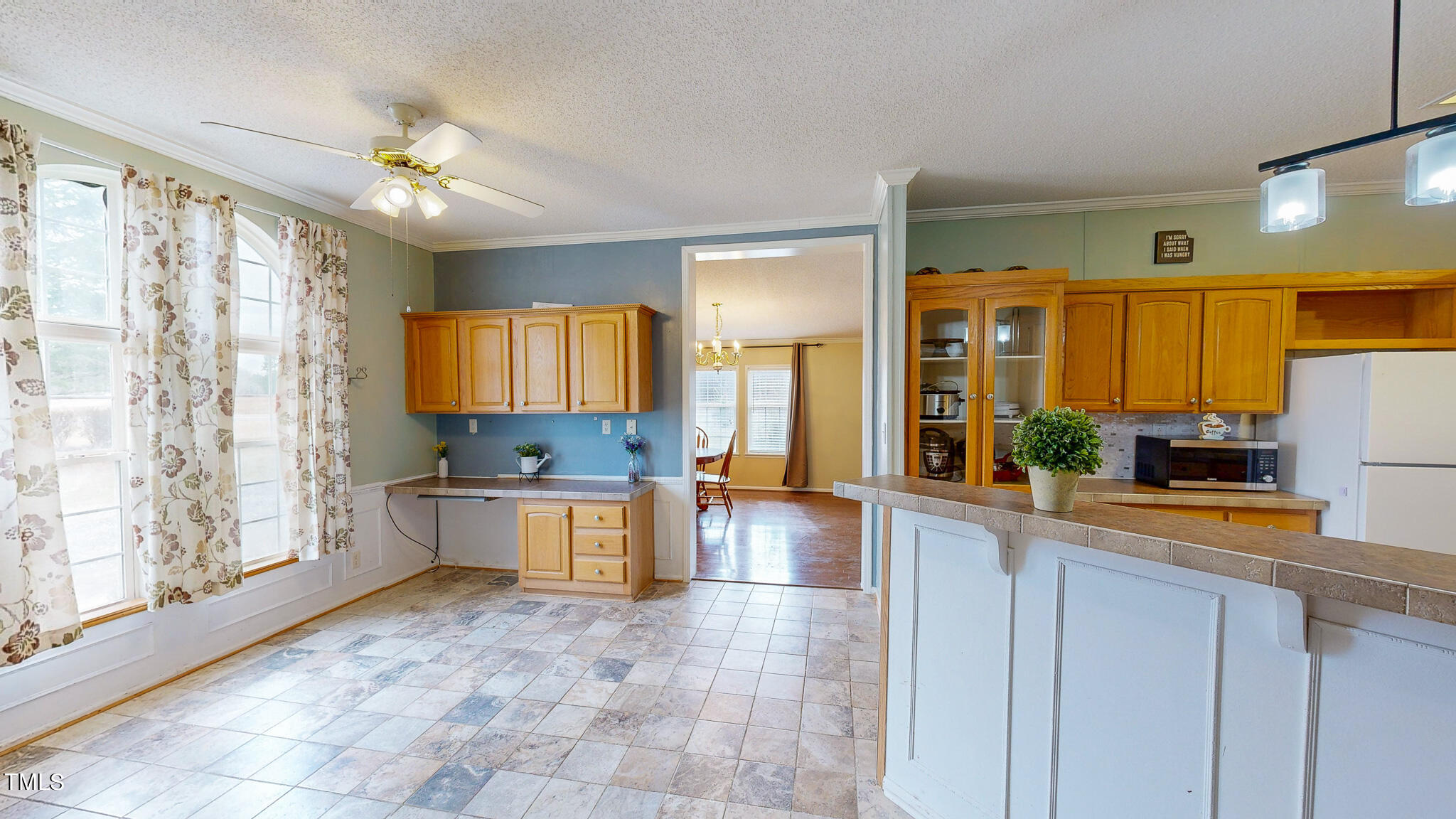 733 Oliver Loop Road Roxboro, NC 27574 - Photo 17 of 28 a large kitchen with kitchen island a large counter space and stainless steel appliances
