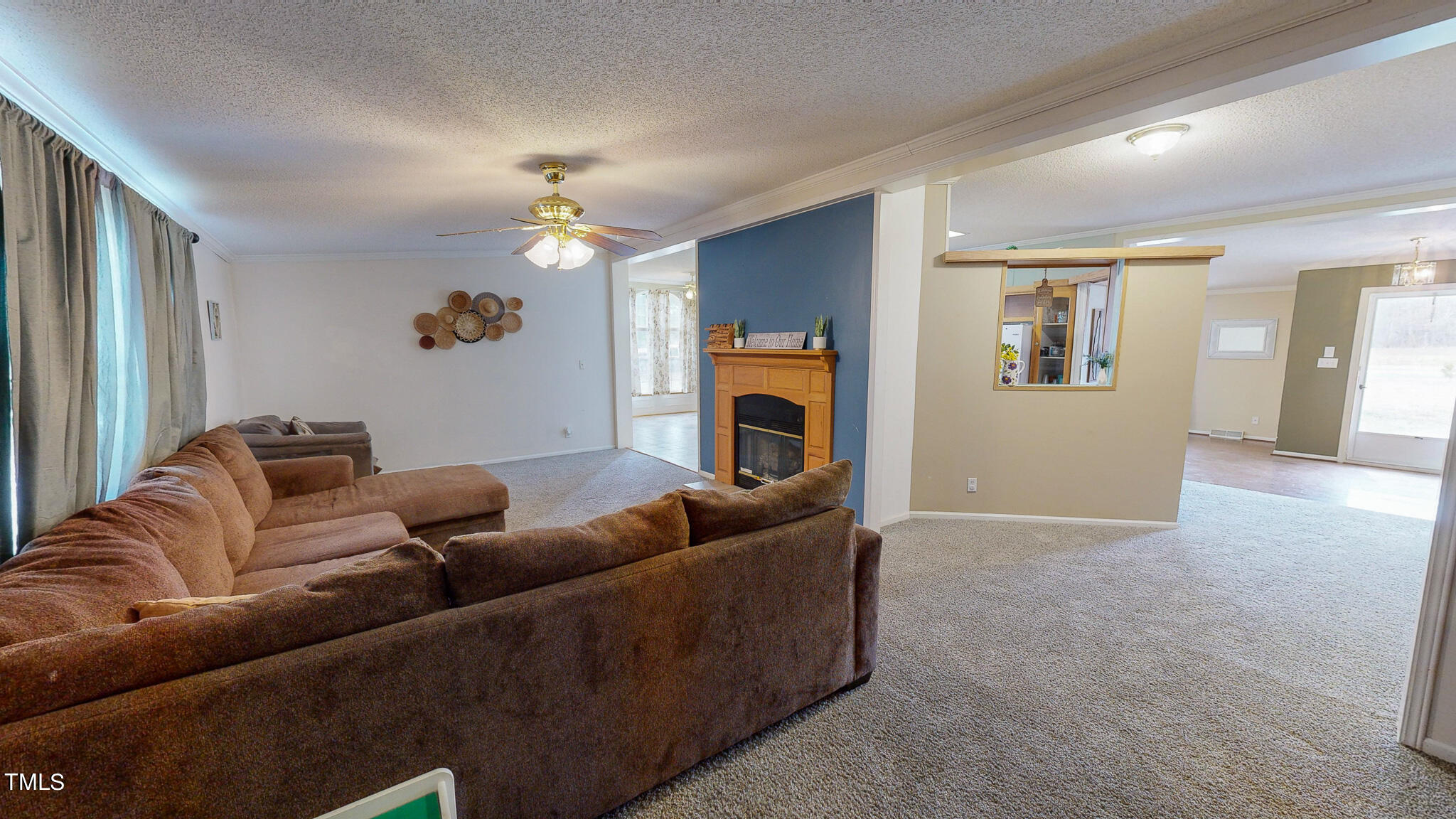 733 Oliver Loop Road Roxboro, NC 27574 - Photo 23 of 28 a living room with furniture a fireplace and a chandelier