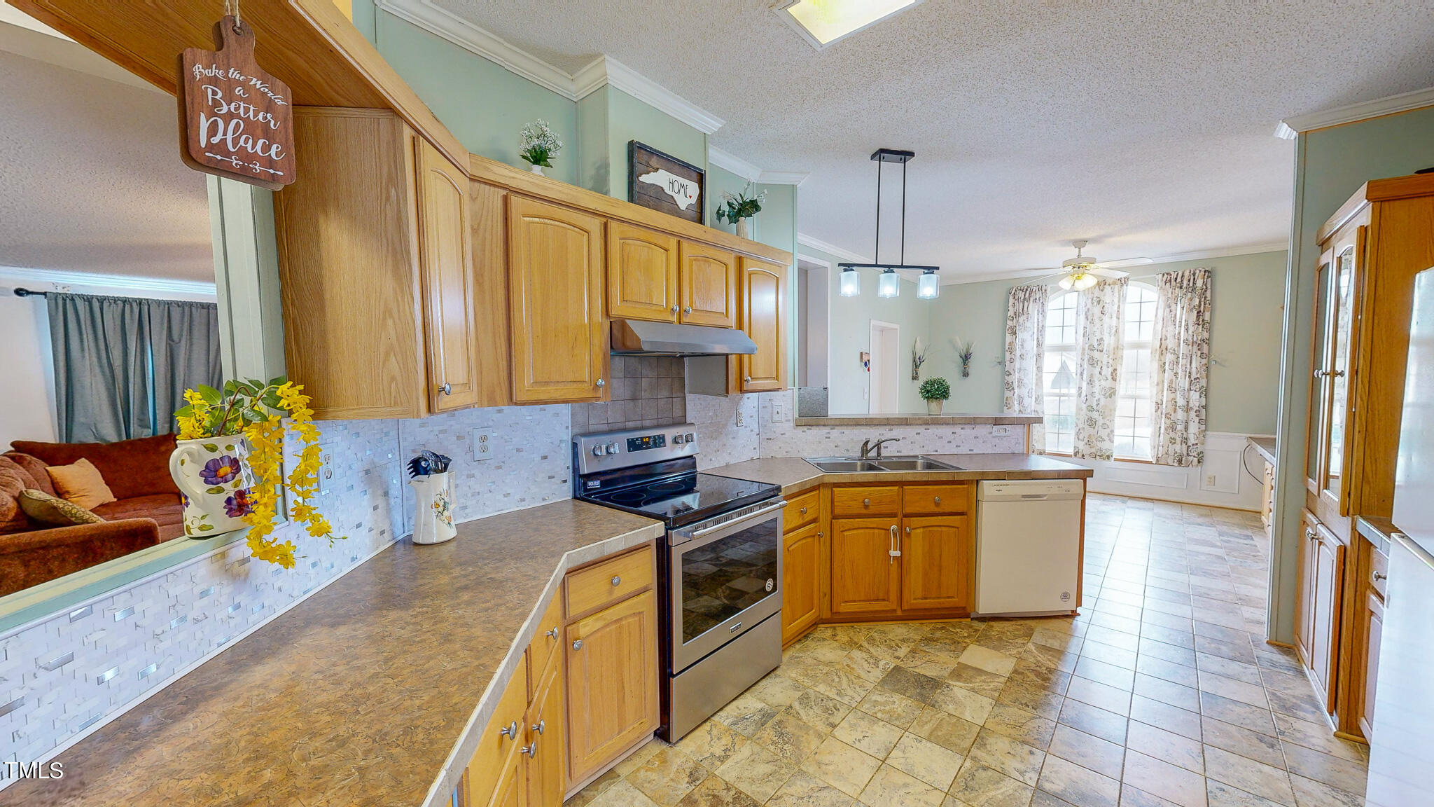 733 Oliver Loop Road Roxboro, NC 27574 - Photo 3 of 28 a kitchen with stainless steel appliances granite countertop a sink a stove and a refrigerator
