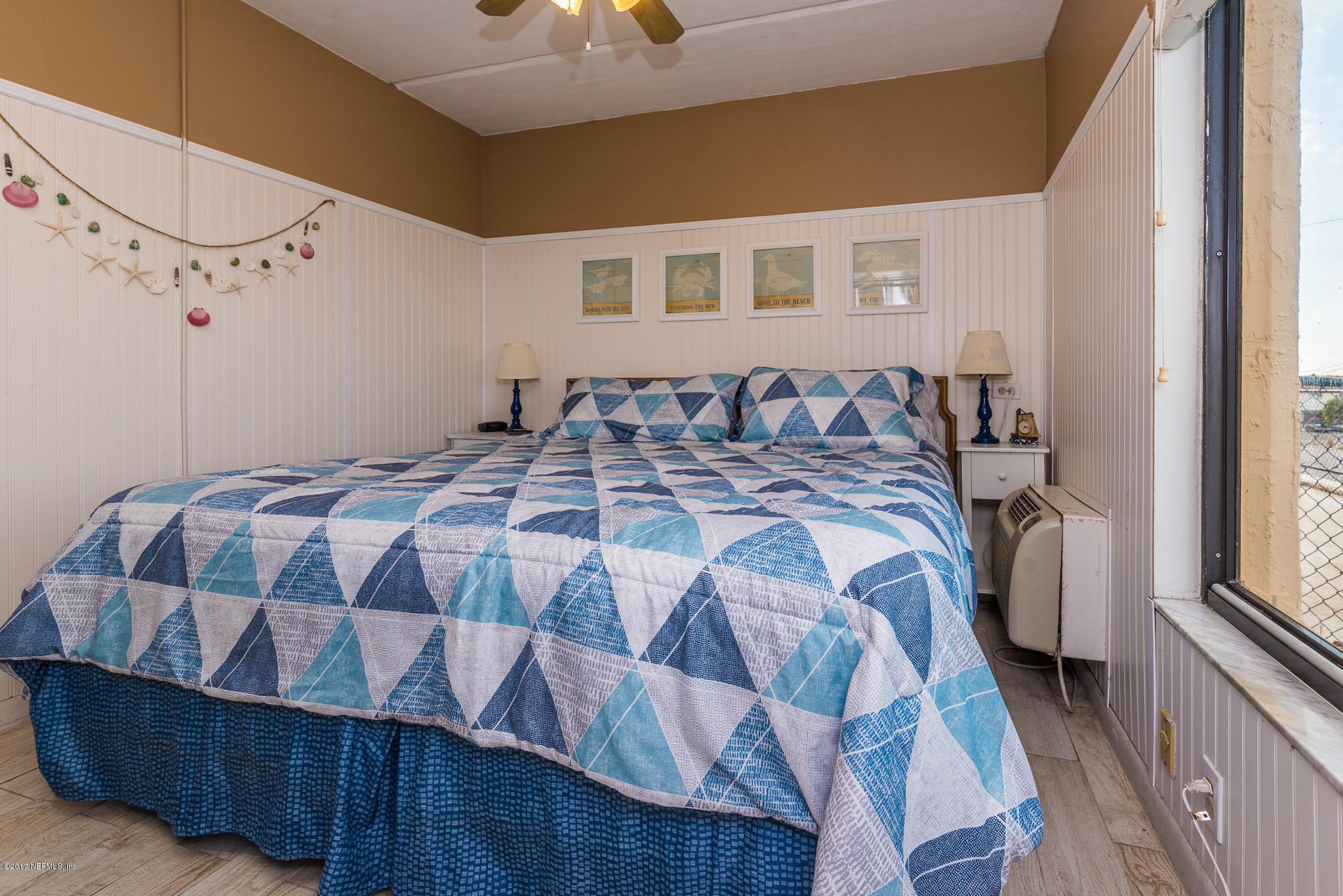 6970 A1A South, Unit 133 St. Augustine, FL 32080 - Photo 11 of 26 a bedroom with a bed mirror and a window