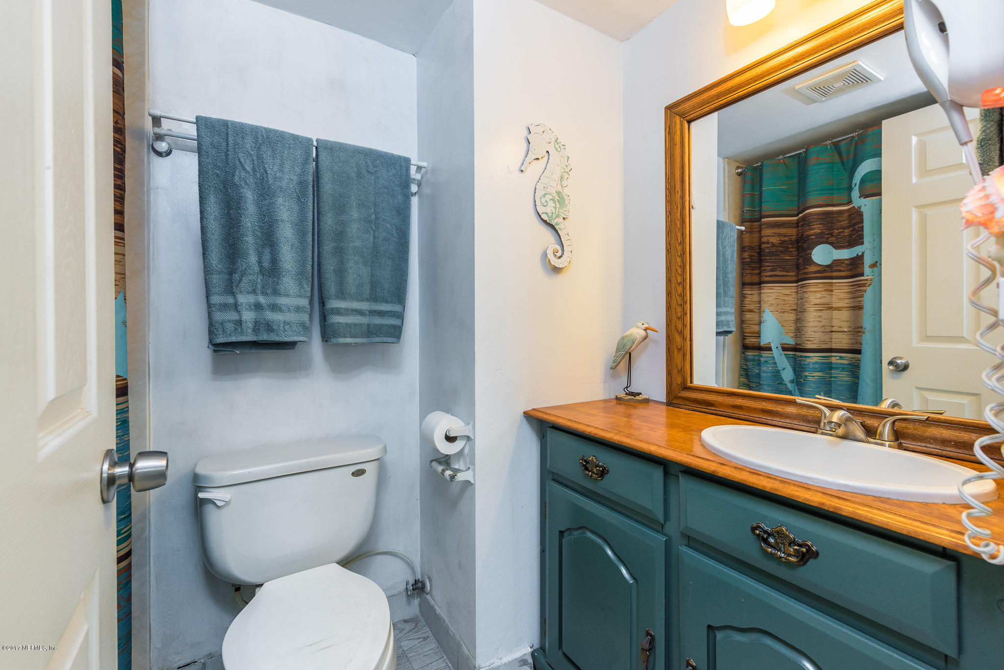 6970 A1A South, Unit 133 St. Augustine, FL 32080 - Photo 12 of 26 a bathroom with a toilet sink and mirror