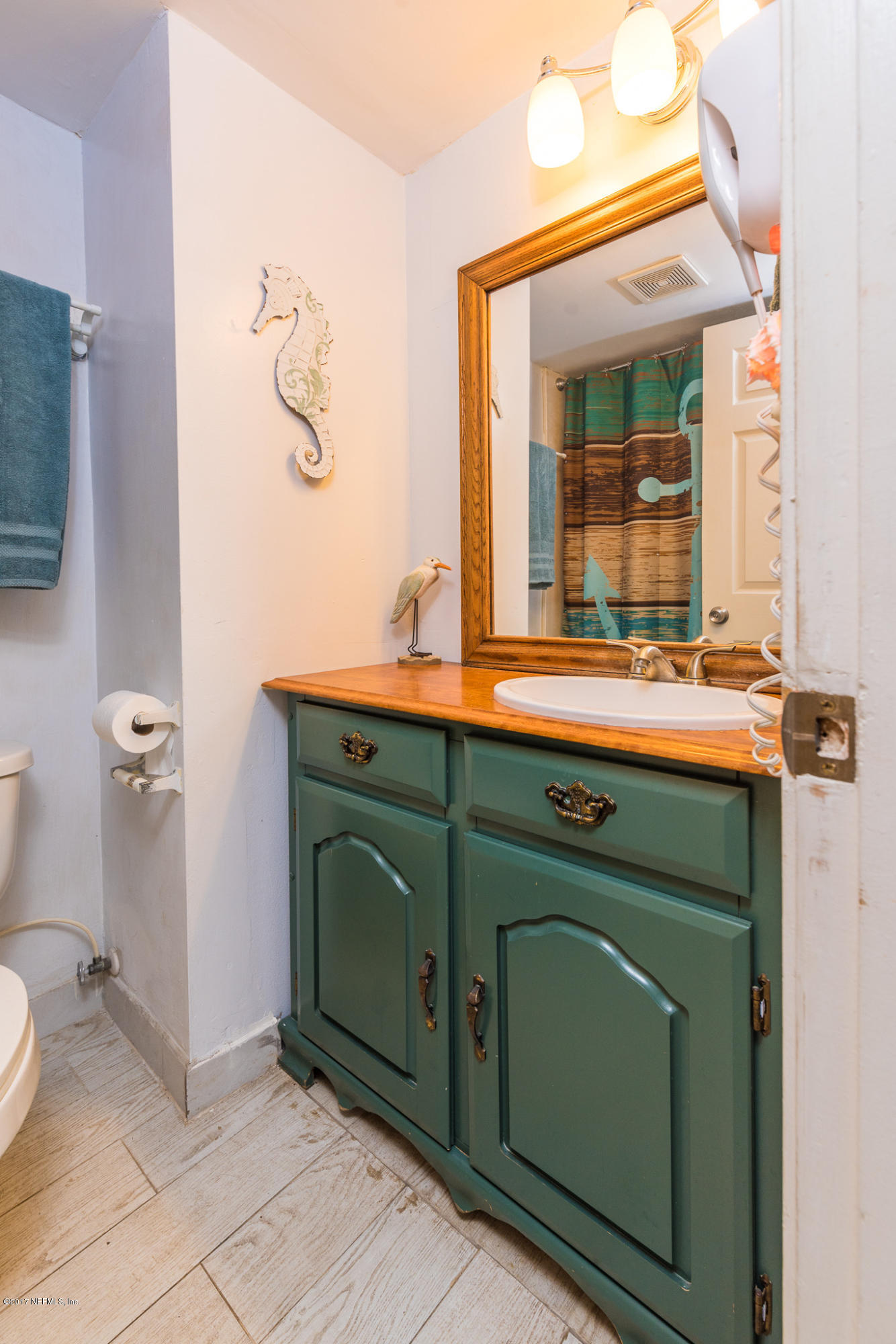 6970 A1A South, Unit 133 St. Augustine, FL 32080 - Photo 13 of 26 a bathroom with a sink and a mirror