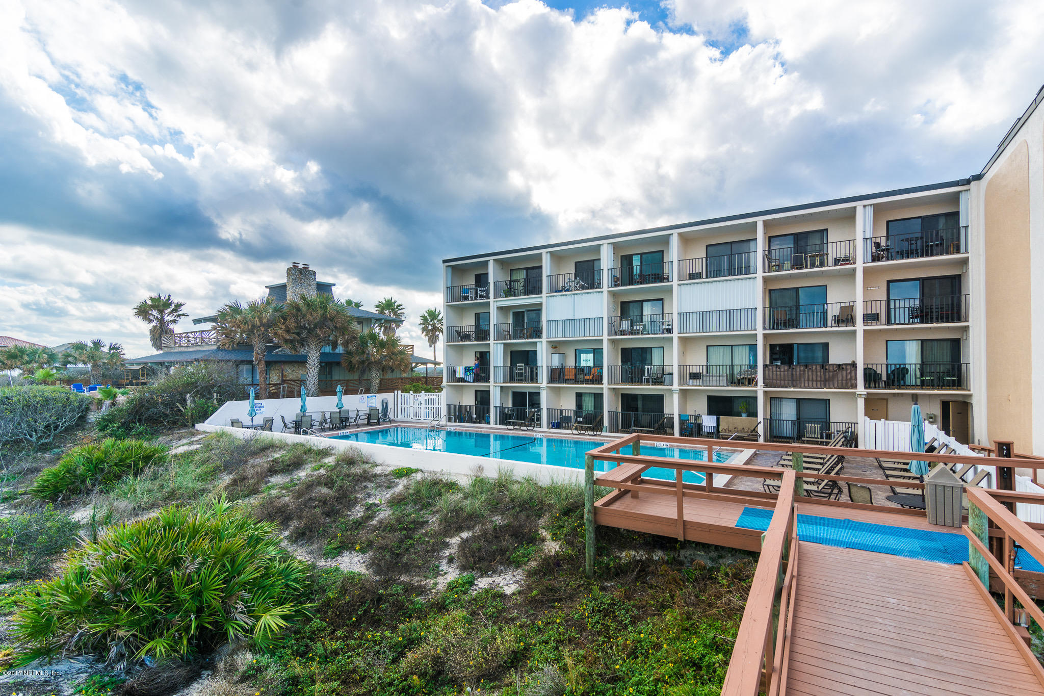 6970 A1A South, Unit 133 St. Augustine, FL 32080 - Photo 16 of 26 a front view of a house with a yard