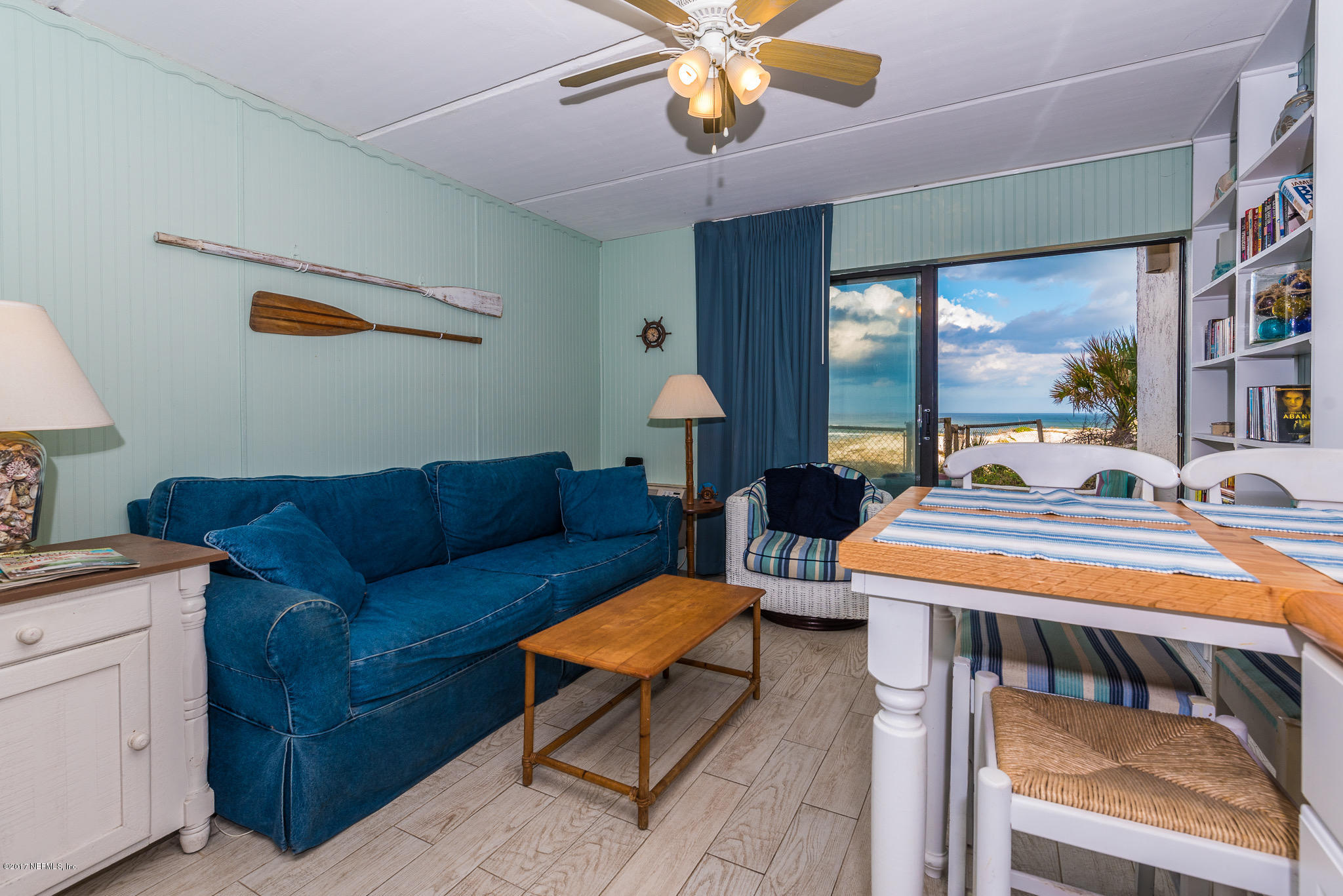 6970 A1A South, Unit 133 St. Augustine, FL 32080 - Photo 3 of 26 a living room with furniture a chandelier and a dining table