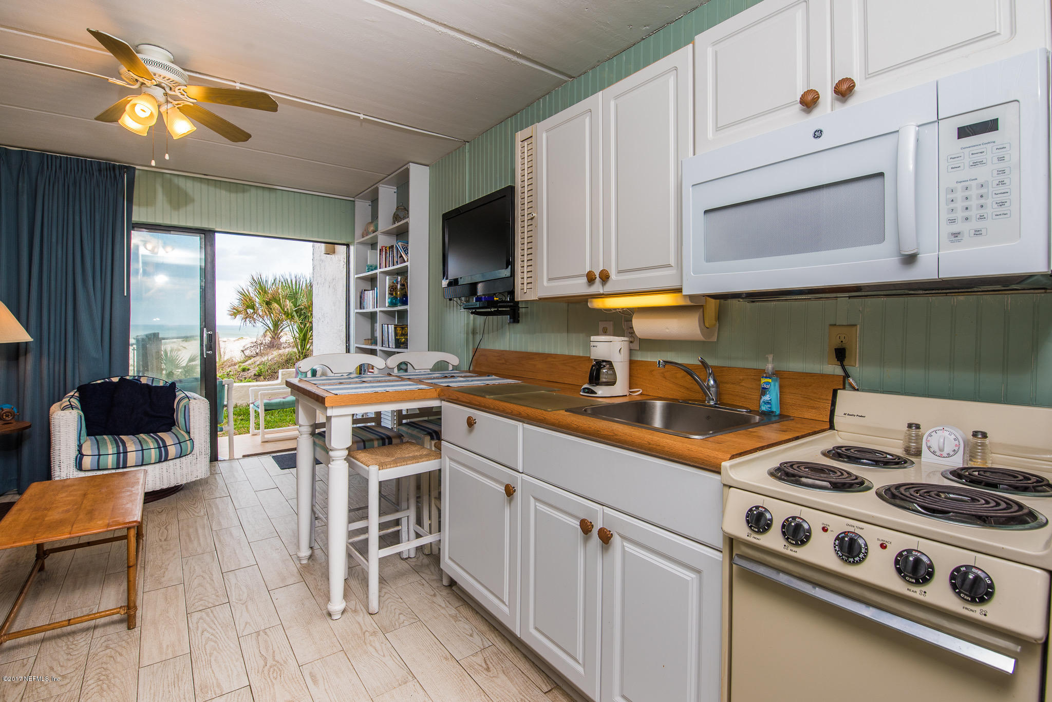 6970 A1A South, Unit 133 St. Augustine, FL 32080 - Photo 6 of 26 a kitchen with a stove a sink and a refrigerator