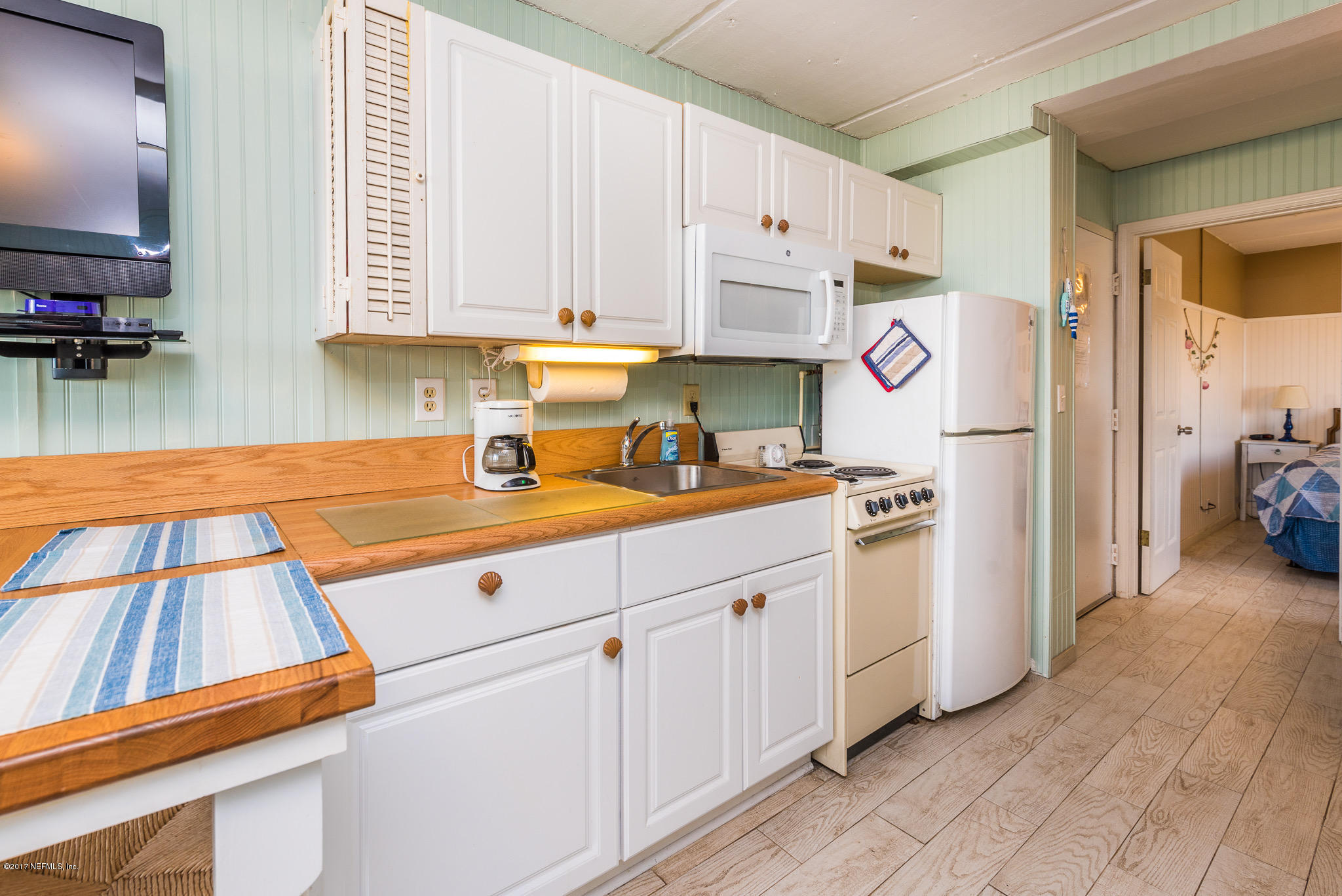 6970 A1A South, Unit 133 St. Augustine, FL 32080 - Photo 8 of 26 a kitchen with stainless steel appliances granite countertop a sink and cabinets