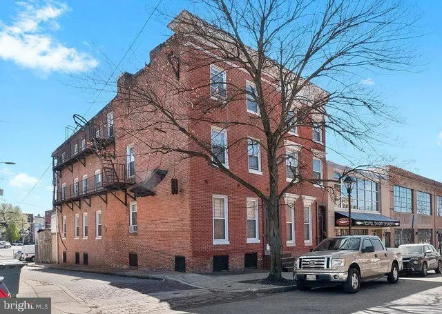 a couple of cars parked in front of brick building