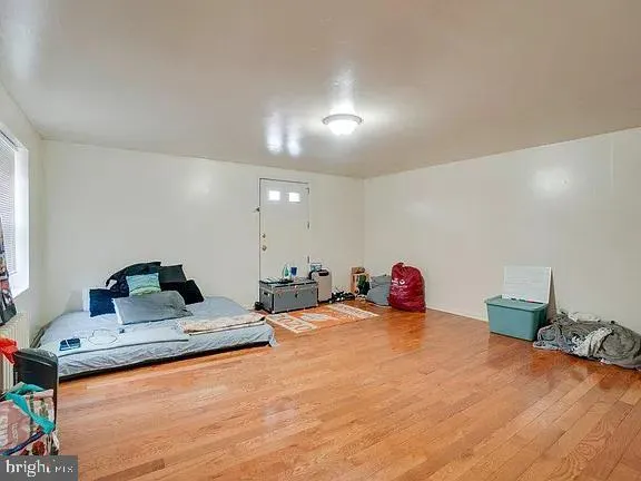a bedroom with furniture and a wooden floor