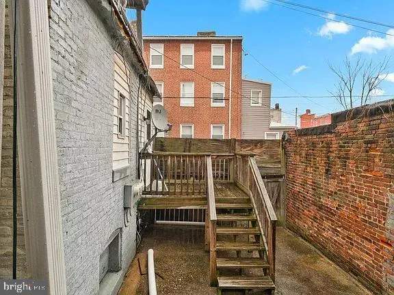 a view of balcony with wooden floor and fence