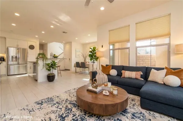 a large kitchen with stainless steel appliances kitchen island granite countertop a refrigerator and a sink