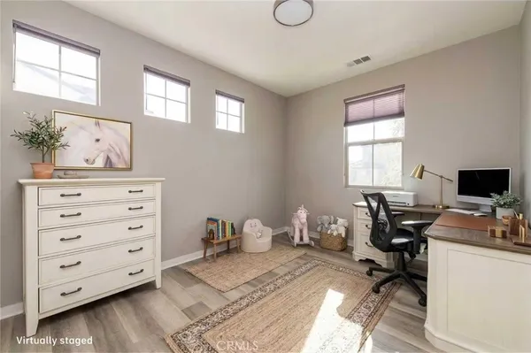 wooden floor in a bedroom and a window