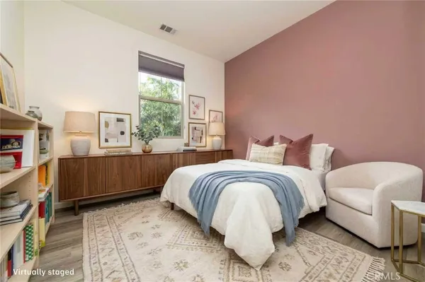 a view of a house with trees and wooden fence