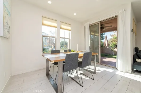 a view of kitchen with stainless steel appliances granite countertop a refrigerator and a stove top oven