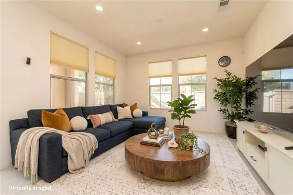 a kitchen with a sink a refrigerator and chairs
