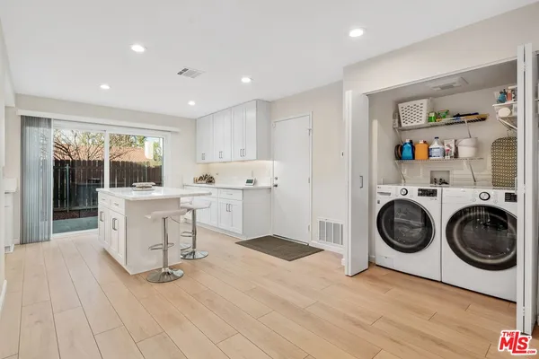 a view of kitchen with furniture and wooden floor