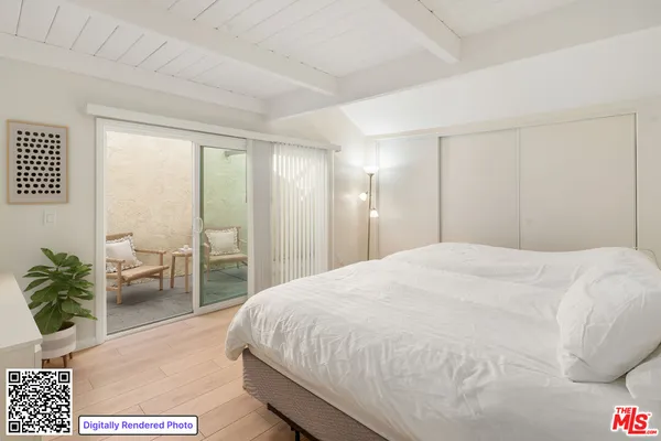 a spacious bedroom with a bed and a couch