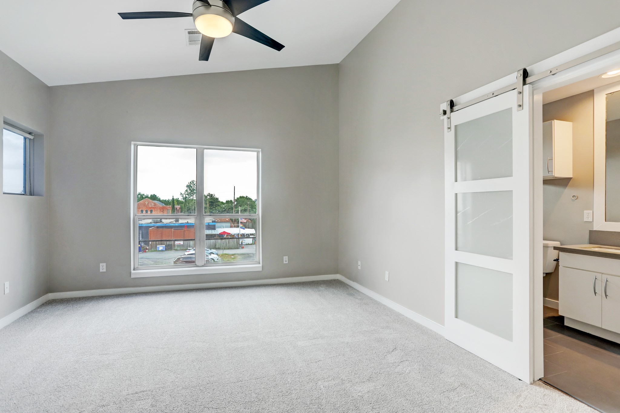 835 Saulnier Street Houston, TX 77019 - Photo 5 of 10 an empty room with windows and fan