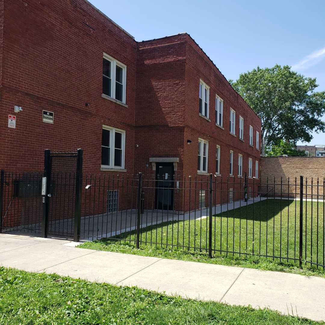 4201 West Division Street, Unit 2 Chicago, IL 60651 - Photo 1 of 7 a view of a house with a yard in front of it