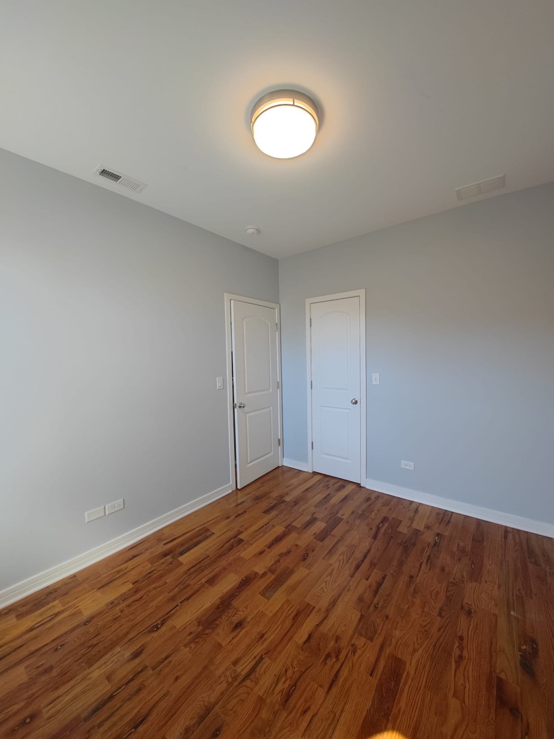 4201 West Division Street, Unit 2 Chicago, IL 60651 - Photo 5 of 7 a view of empty room with wooden floor
