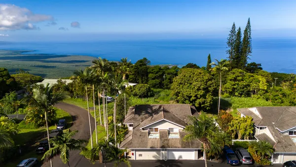 an aerial view of a house with a yard