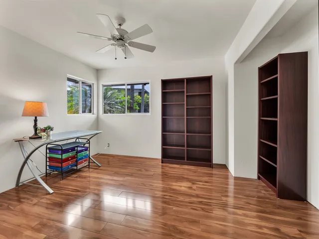 a view of a workspace with furniture and window