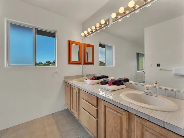 a bathroom with a sink a vanity and a mirror