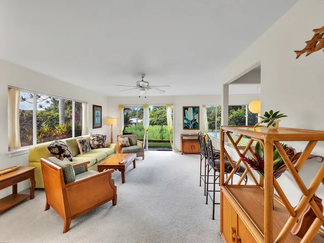 a living room with furniture cabinets and a floor to ceiling window