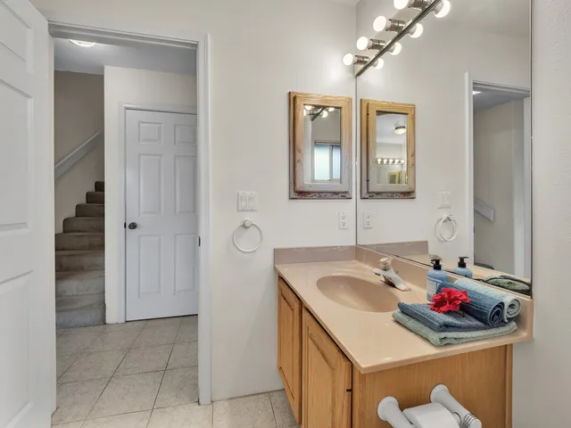 a bathroom with a sink vanity and a mirror