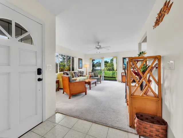 a view of living room kitchen and patio area