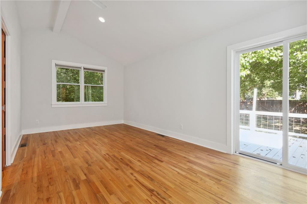 385 Sunset Drive Athens, GA 30606 - Photo 31 of 48 an empty room with wooden floor and windows