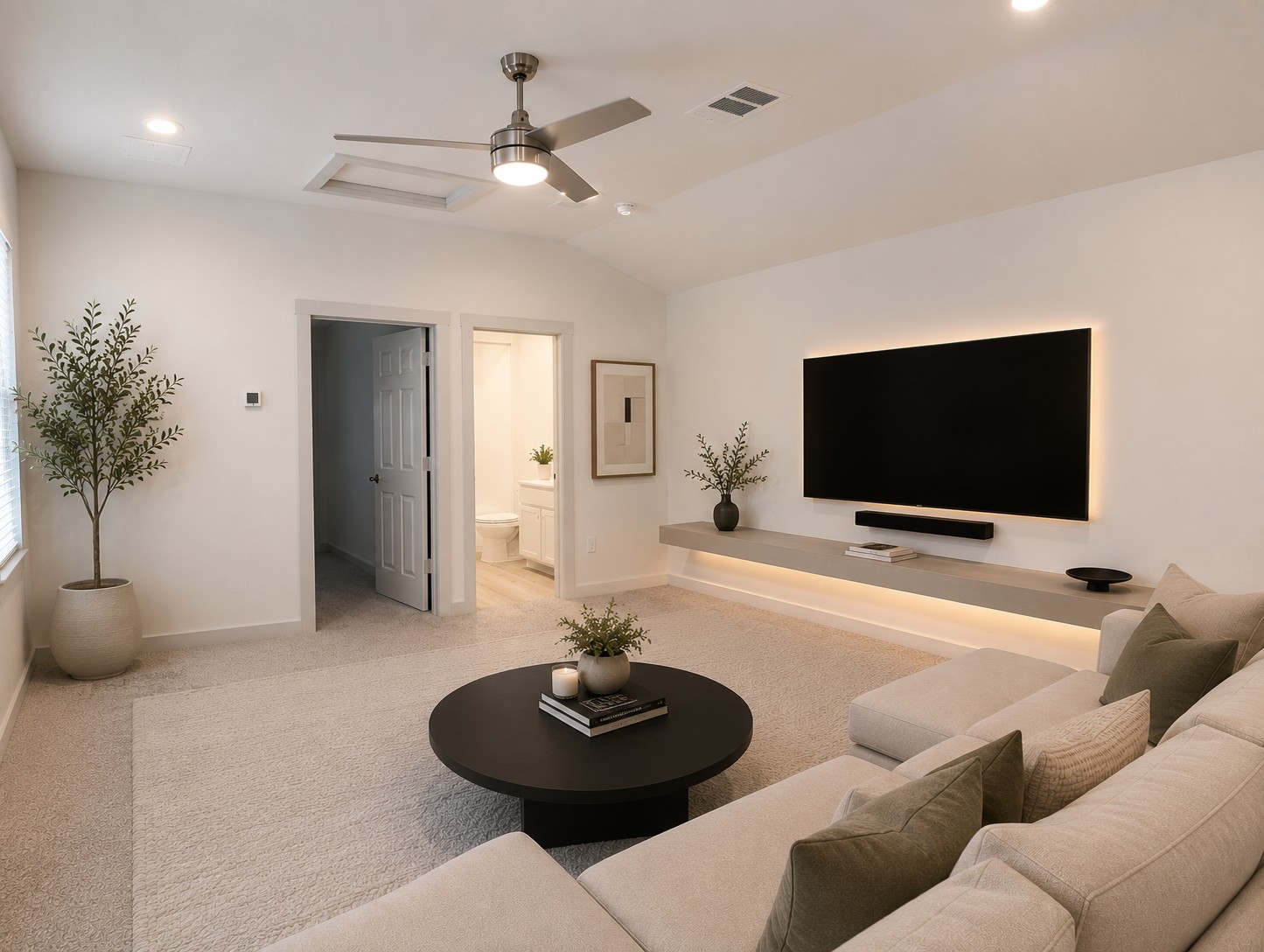 261 Century Plant Road Leander, TX 78641 - Photo 17 of 25 Virtually staged 2nd floor loft. An inviting family room awaits, showcasing a modern ceiling fan and integrated lighting above plush carpeting.
