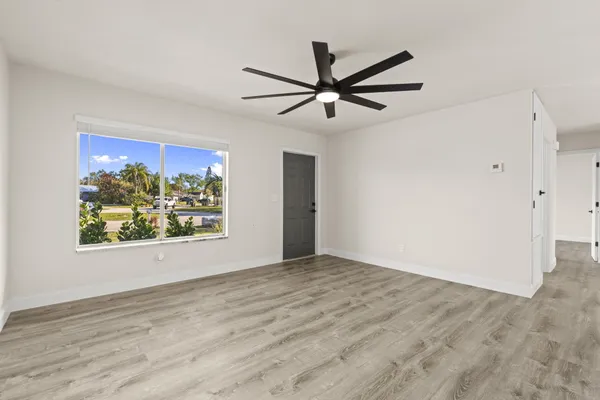 a view of room with window and ceiling fan