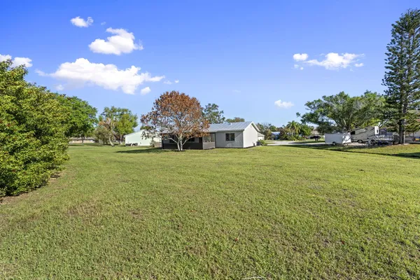 a view of a house with a yard and garage