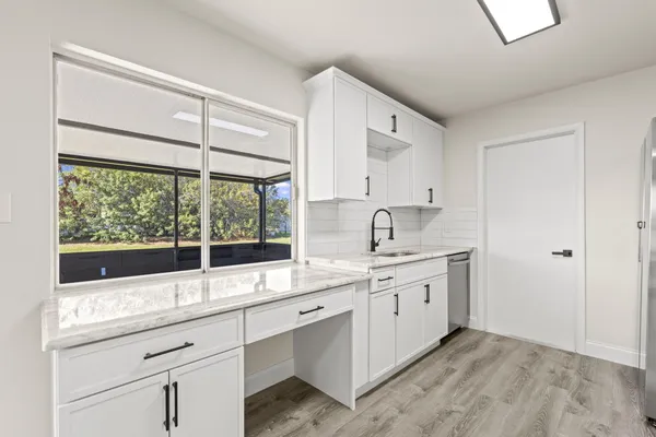 a kitchen with a sink and large window