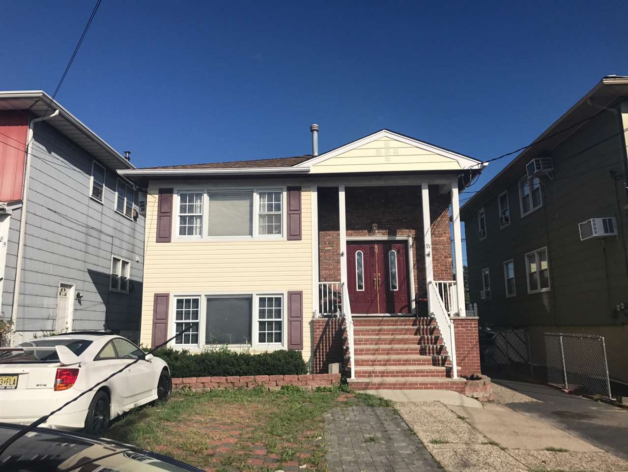 91 Country Village Road Jersey City, NJ 07305 - Photo 1 of 1 a front view of a house with a yard