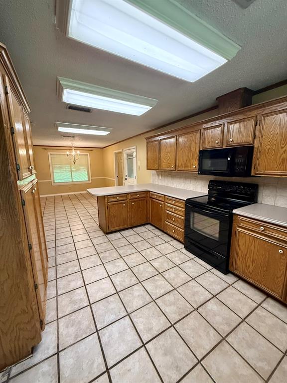 11535 Timber Ridge Drive Keithville, LA 71047 - Photo 5 of 39 a large kitchen with a stove a sink dishwasher and a refrigerator