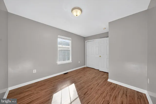 a view of a room with wooden floor