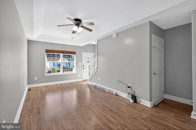 a large kitchen with stainless steel appliances granite countertop a lot of counter space and wooden floors