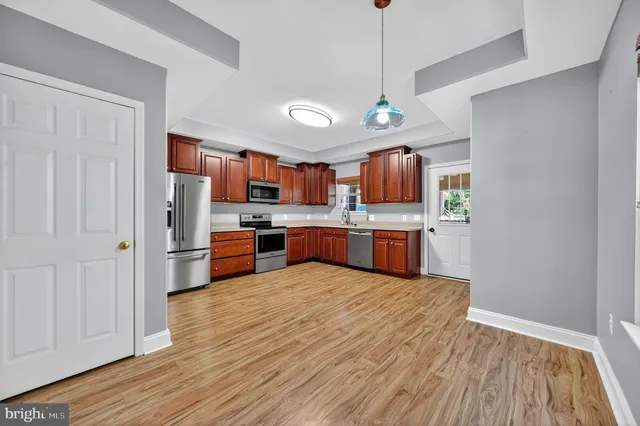 a kitchen with stainless steel appliances granite countertop a refrigerator stove and sink