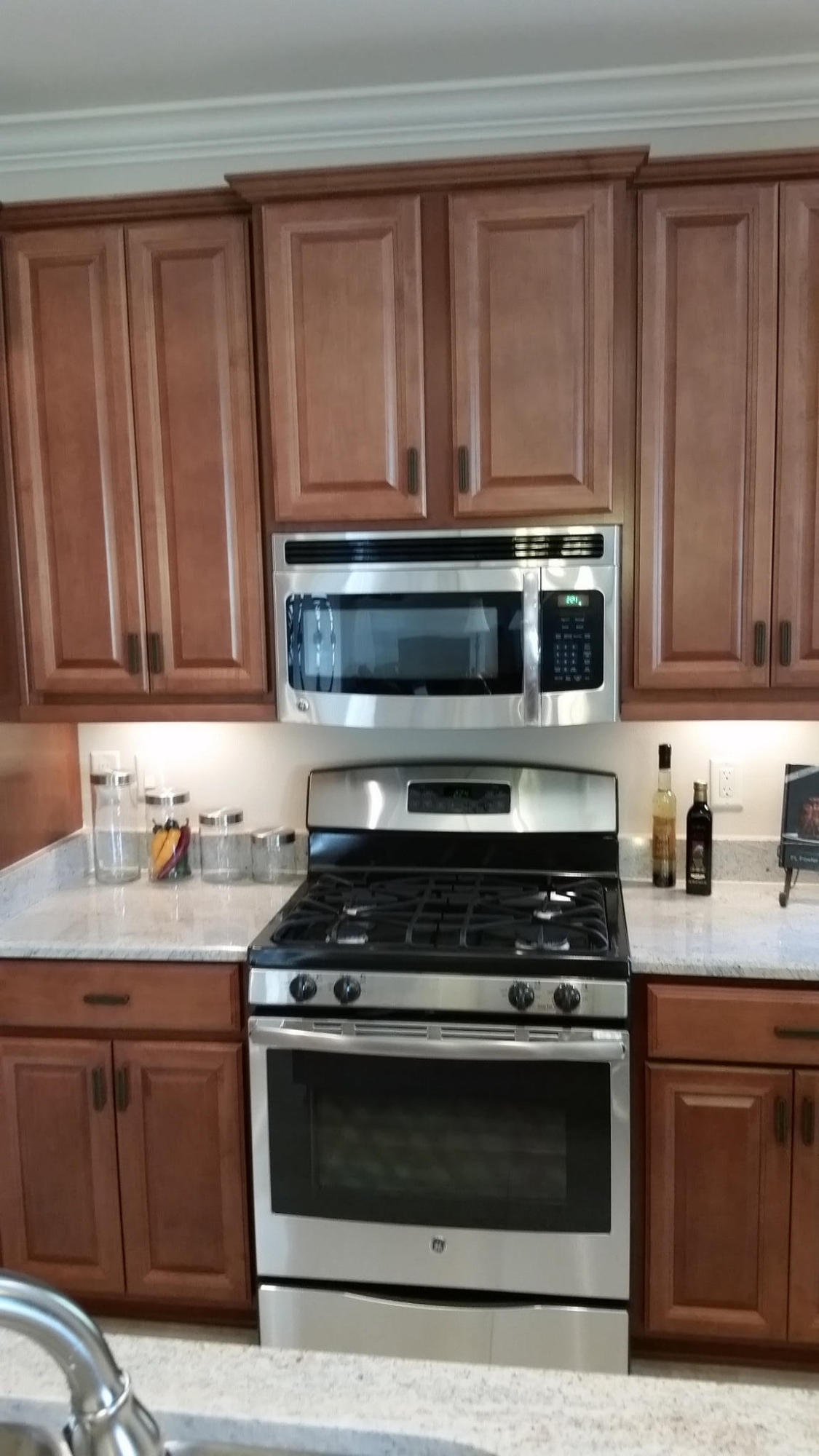 205 Rigdon Court Northwest Fort Walton Beach, FL 32548 - Photo 11 of 48 a kitchen with granite countertop stainless steel appliances a stove a microwave and sink