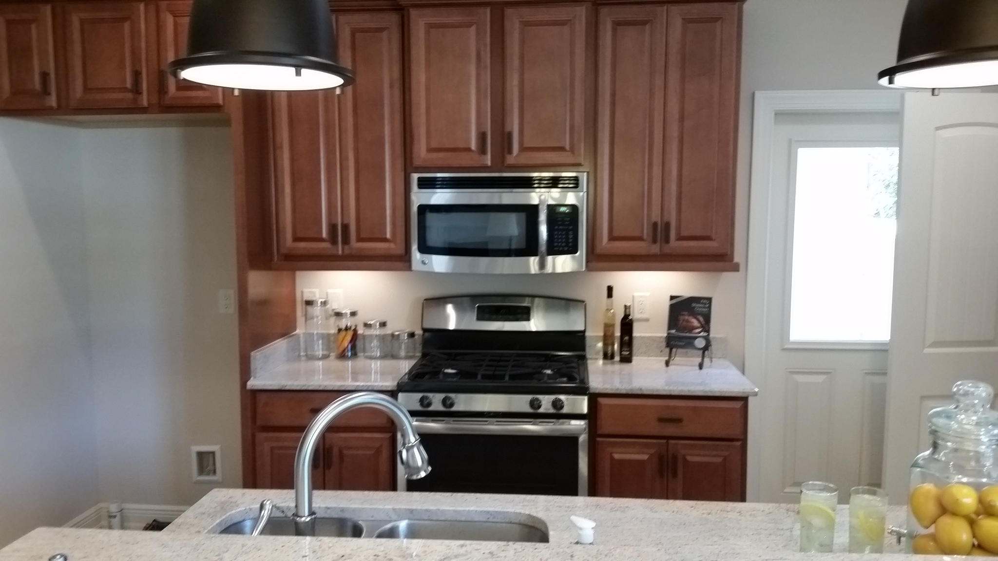 205 Rigdon Court Northwest Fort Walton Beach, FL 32548 - Photo 10 of 48 a kitchen with granite countertop a stove top oven microwave and cabinets
