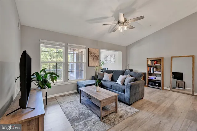 a living room with furniture a chandelier and a window