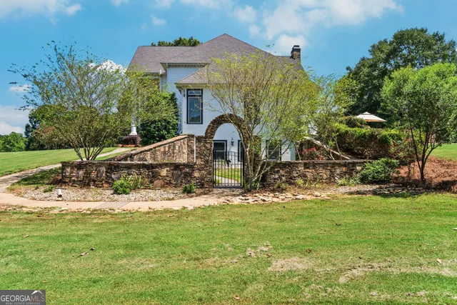 a front view of a house with a yard table and chairs