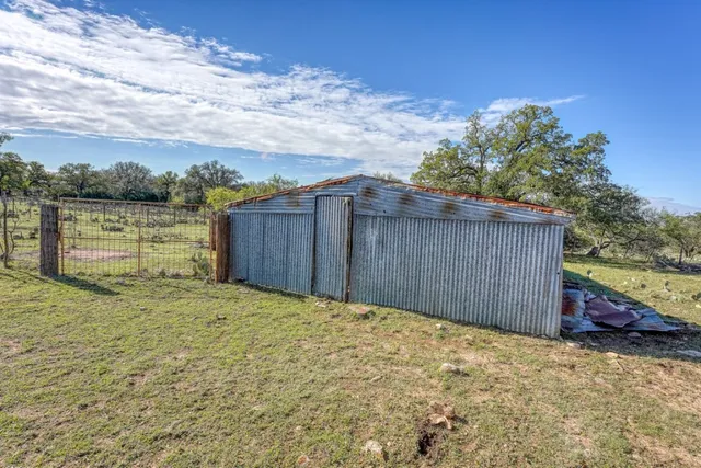 a view of field with trees in background
