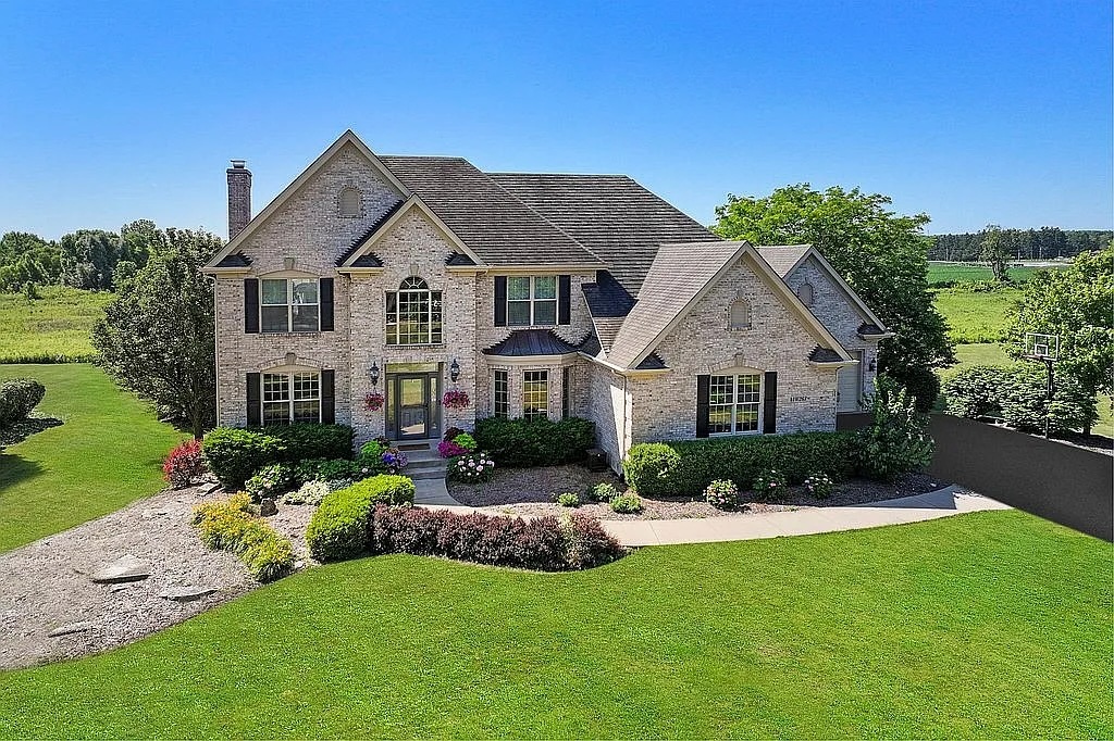 a front view of a house with a yard and garage